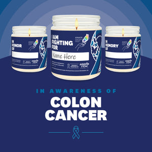 Colon Cancer Awareness soy candle in a 9 oz glass jar, in collaboration with GRACE, from Angela Rose Studios. Choose from three messages: "I Am Fighting For," "In Honor Of," or "In Memory Of," and personalize it with the name of your loved one. Each candle supports cancer patients, with 100% of proceeds donated to Greater Richland Area Cancer Elimination, Inc.