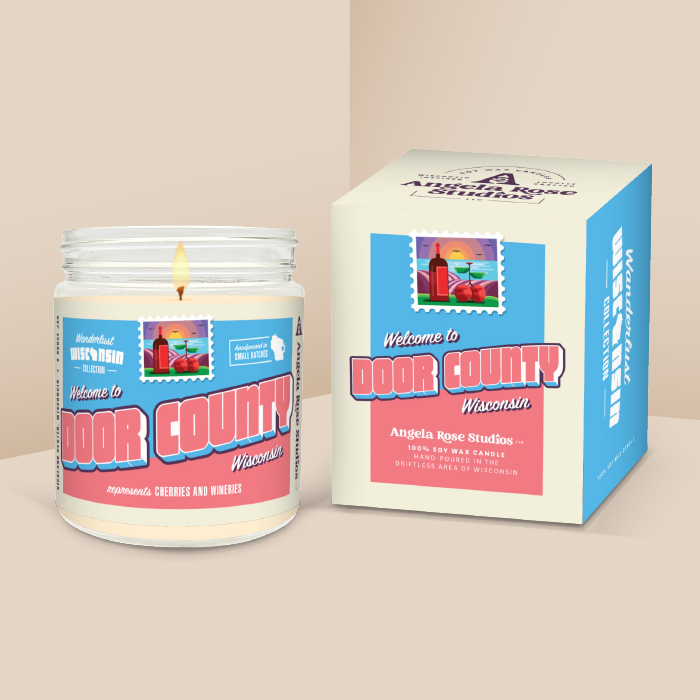 Door County soy candle in a 9 oz glass jar with packaging box, from the Wanderlust Wisconsin Collection by Angela Rose Studios.