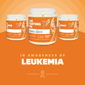 Leukemia Awareness soy candle in a 9 oz glass jar, in collaboration with GRACE, from Angela Rose Studios. Choose from three messages: "I Am Fighting For," "In Honor Of," or "In Memory Of," and personalize it with the name of your loved one. Each candle supports cancer patients, with 100% of proceeds donated to Greater Richland Area Cancer Elimination, Inc.