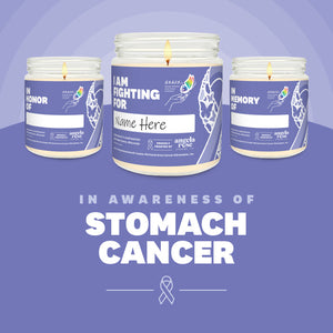 Stomach Cancer Awareness soy candle in a 9 oz glass jar, in collaboration with GRACE, from Angela Rose Studios. Choose from three messages: "I Am Fighting For," "In Honor Of," or "In Memory Of," and personalize it with the name of your loved one. Each candle supports cancer patients, with 100% of proceeds donated to Greater Richland Area Cancer Elimination, Inc.