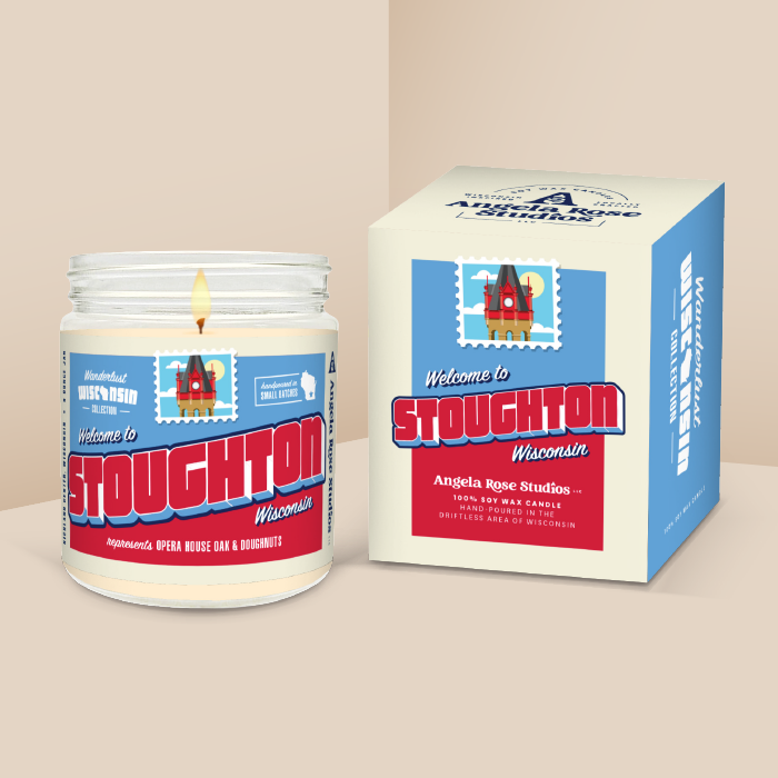Stoughton soy candle in a 9 oz glass jar with packaging box, from the Wanderlust Wisconsin Collection by Angela Rose Studios.